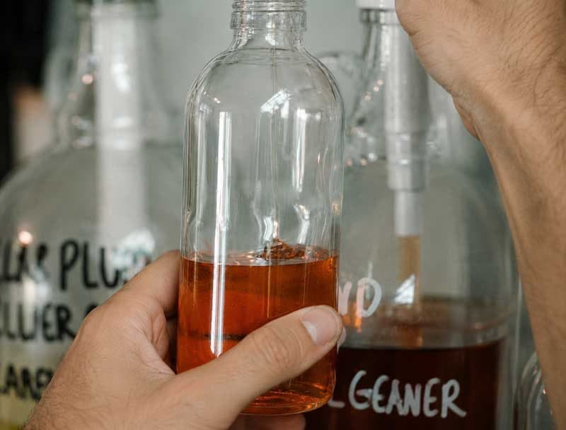 Hand-mixed natural cleaning solution in a glass bottle