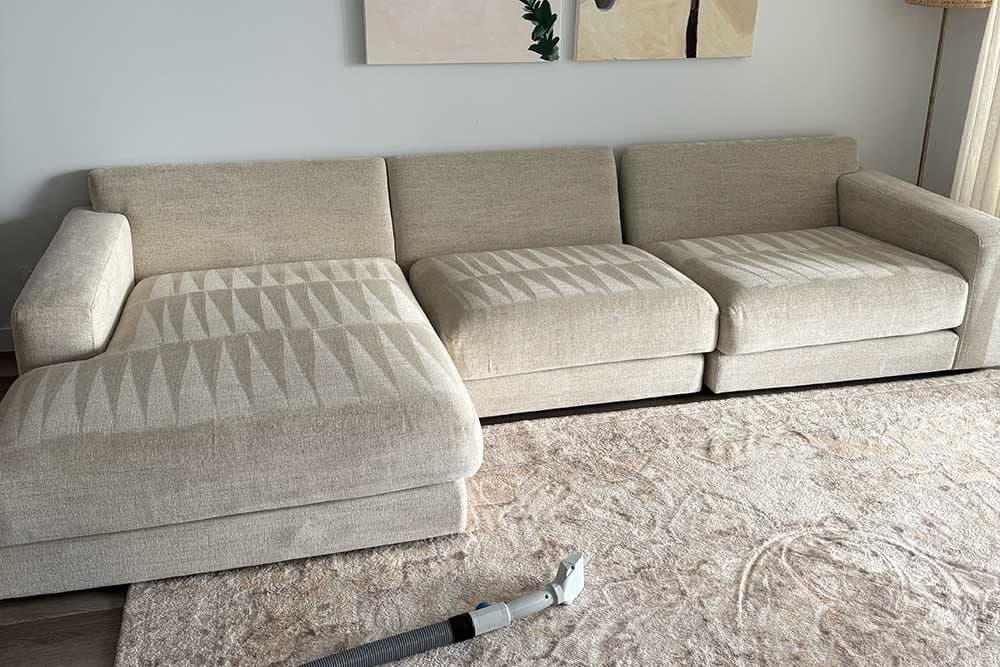 Freshly cleaned beige modular lounge and rug in a Sunshine Coast living room